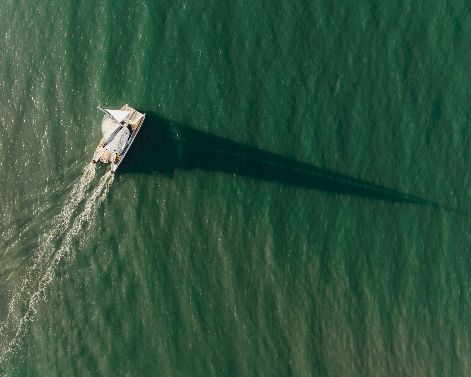 Aerial view of a sailing boat on the water near Port Douglas