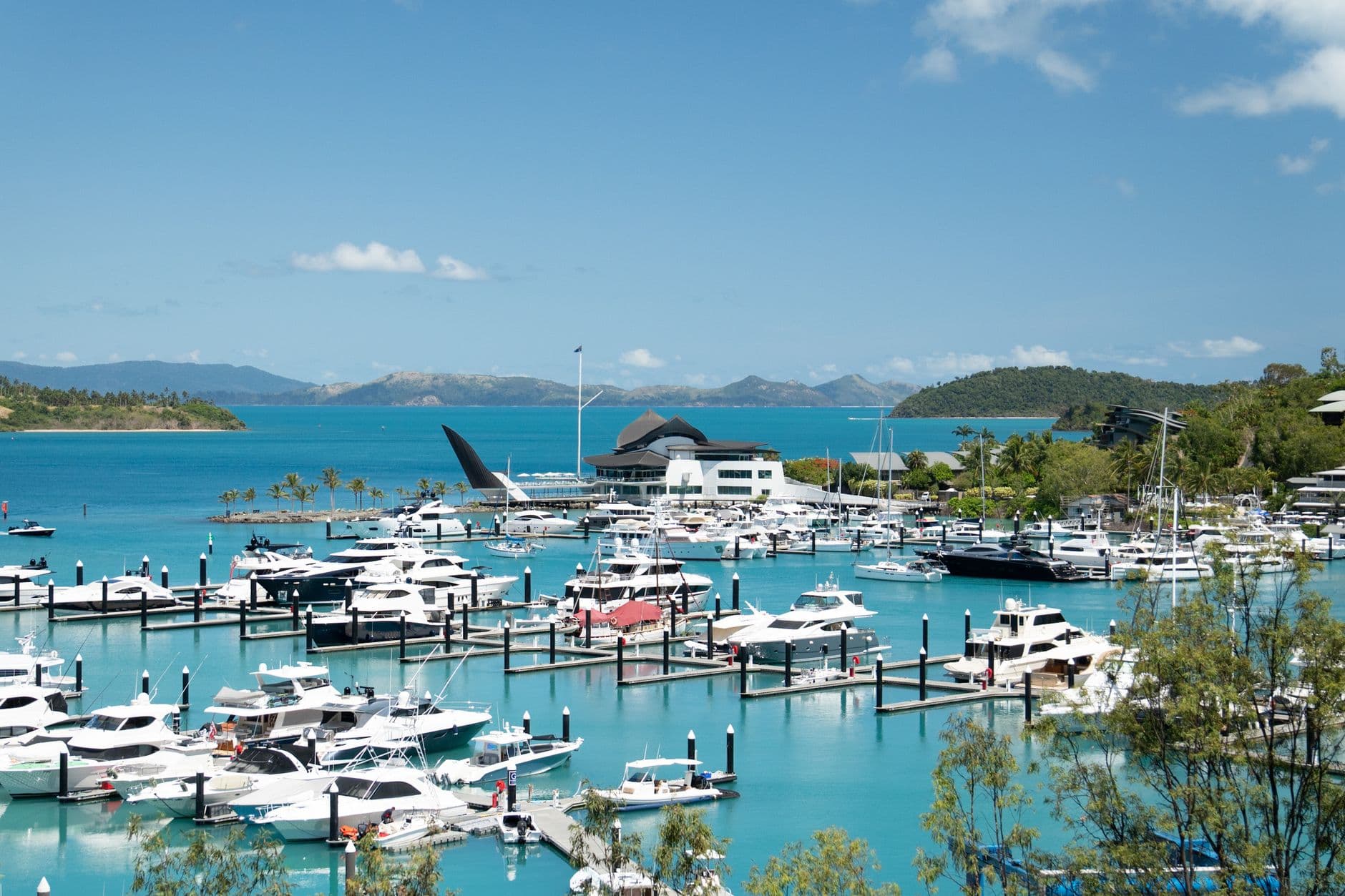 Boats in Hamilton Island Marina with Whitsundays islands beyond