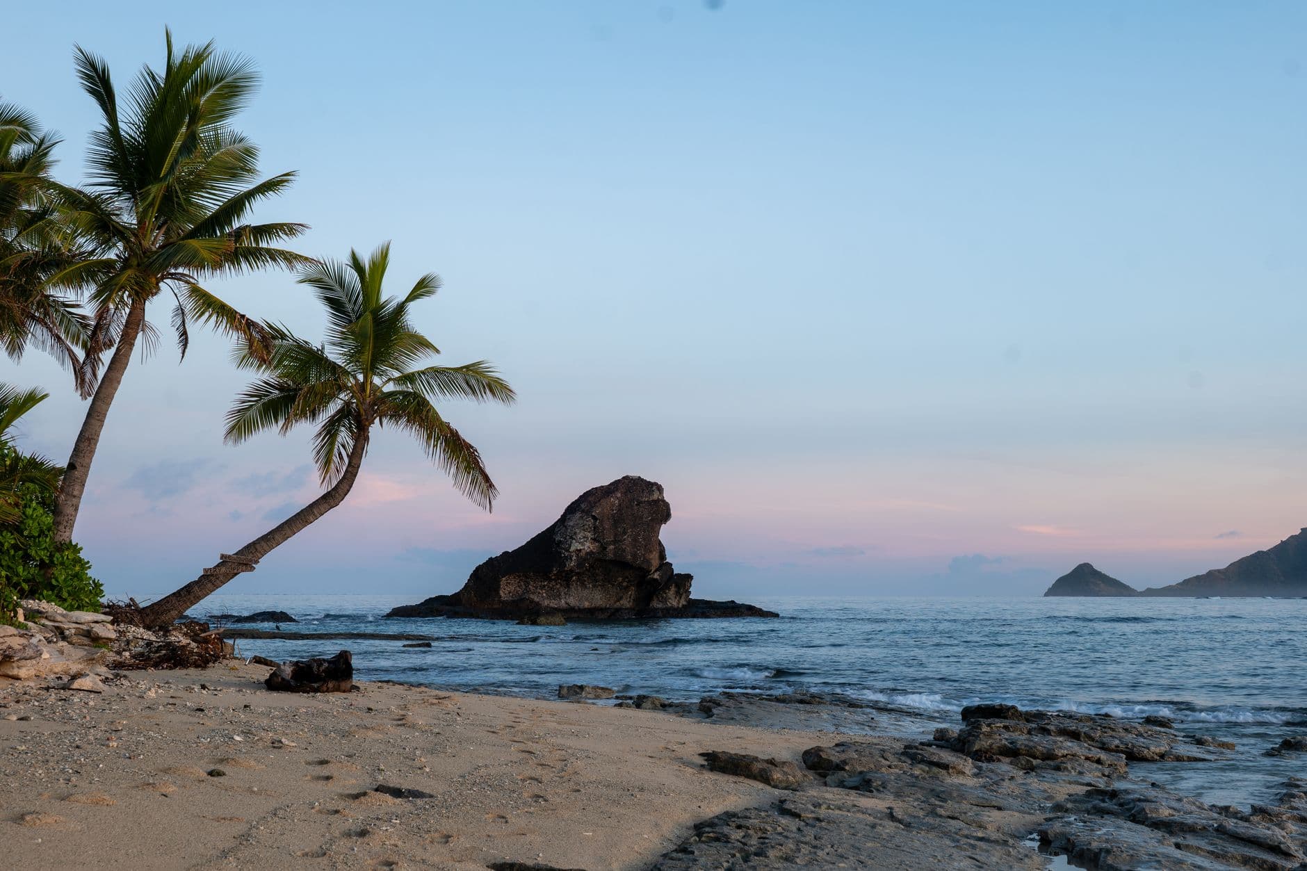 Sunrise over a palm-fringed beach in Fiji